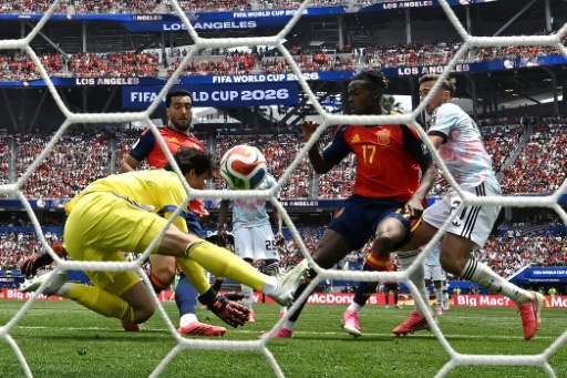 Mikel Merino (in the red shirt) pokes in the goal that secured Spain's passage to the World Cup semi-finals