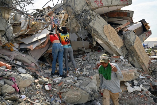 Locals attempt to recover belongings at the site of a collapsed building in Caraballeda, Venezuela, eight days after twin earthquakes leveled parts of the country
