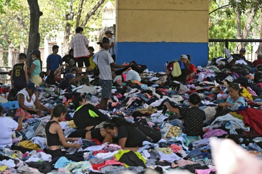 People sift through clothing at a donation center in Caraballeda, La Guaira state
