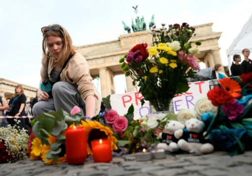 In a vigil, hundreds of people packed out the square in front of the Brandenburg Gate — RALF HIRSCHBERGER / AFP