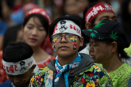 People wearing head bands with the portrait of General Aung San arrive to pay their respect before the Martyr's Mausoleum in Yangon in July 2018 — YE AUNG THU / AFP