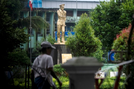 A woman walks past a statue of Myanmar’s independence General Aung San at Thu Mingalar Park — - / AFP