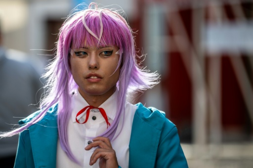 A cosplayer visits the Osu Shopping Street before the Osu Cosplay Parade, during the second day of the World Cosplay Summit 2026 in Nagoya on August 1, 2026. — Philip FONG / AFP