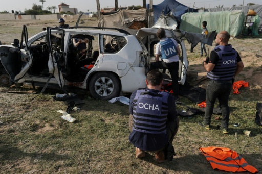 United Nations staff inspect the wreckage of a car used by the aid group World Central Kitchen after it was hit by an Israeli strike in Deir al-Balah in the central Gaza Strip in April 2024 — - / AFP