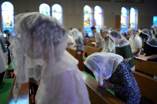People pray at a mass held at Urakami Cathedral on August 9, 2026 in Nagasaki, marking the 81st anniversary of the atomic bombing — JIJI PRESS / AFP