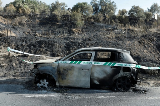 A burned car is pictured west of Madrid, on July 26, 2026 — Oscar DEL POZO / AFP