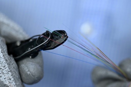 Technicians work around the clock to turn glass into hair-thin fibre-optic strands destined for data centres — Indranil MUKHERJEE / AFP