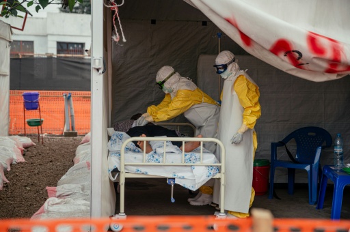 Doctors Without Borders (MSF) physicians move through the isolated red zone to monitor patients at an Ebola Treatment Center in Munigi, Congo — Jospin Mwisha / AFP