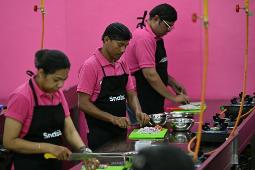At one of Snabbit's training hubs in the southern tech hub of Bengaluru, workers rehearse tasks such as chopping vegetables — Idrees MOHAMMED / AFP