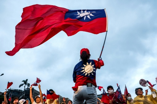 A supporter of Taiwan's main opposition party, Kuomintang (KMT), waves the country's national flag during a rally against the recall election in front of the Presidential Office in Taipei on July 25, 2025