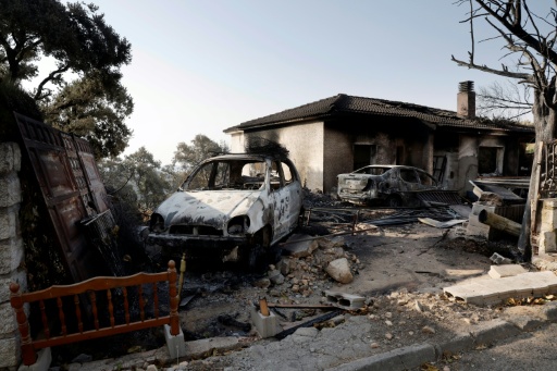 Una propiedad y un vehículo devorados por las llamas en la zona residencial de Encinar del Alberche, en la localidad española de Villa del Prado, al suroeste de Madrid, en una imagen del 30 de julio de 2026 — Óscar del Pozo / AFP