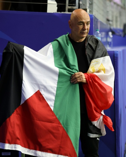 Egypt coach Hossam Hassan waved a Palestine flag after his side's World Cup win over Australia