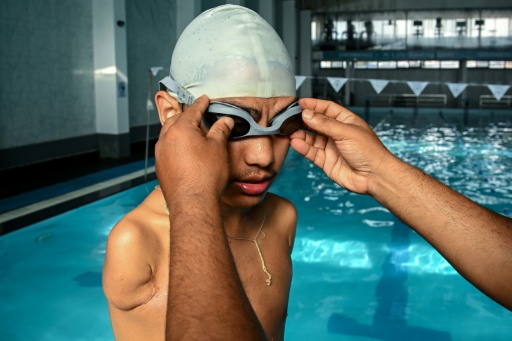 Harka Man Gharti being assisted by his coach for a training session — Prakash MATHEMA / AFP