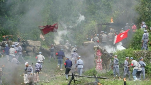 Explosions, red flags: Chinese tourists reenact communist victory