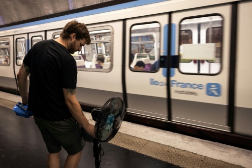 Une personne prend le métro avec un ventilateur, à Paris, le 10 juillet 2026