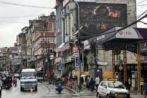 A digital billboard (top, R) displays the condolences after the death of mountaineer Nirmal Purja and his companions by an avalanche in Pakistan — Prakash MATHEMA / AFP