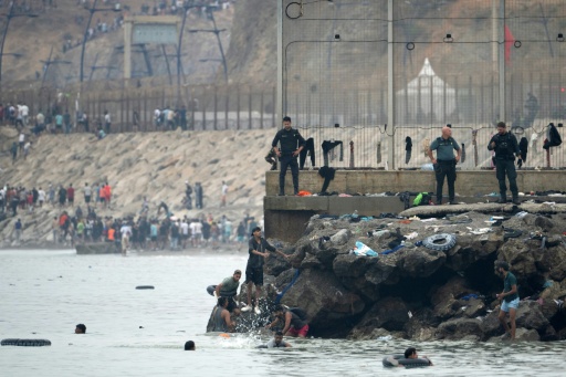 Many of the migrants have been swimming around a border barrier to get to Cueta — JORGE GUERRERO / AFP