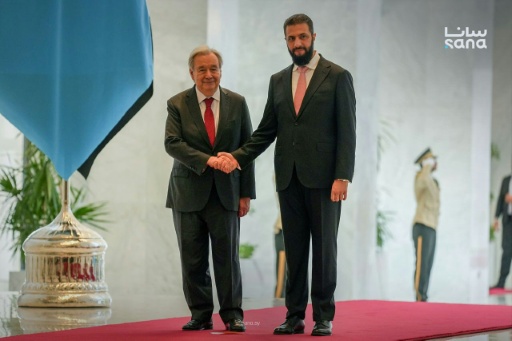 Photo fournie par l'agence de presse syrienne Sana le 25 juillet 2026 montrant le secrétaire général de l'ONU, Antonio Guterres (G) serrant la main du président syrien Ahmad al-Chareh (D) au palais présidentiel à Damas — - / AFP