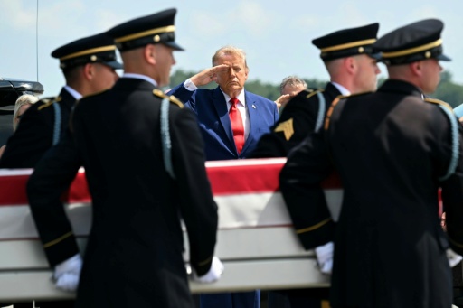 US President Donald Trump salutes as an Army team carries the flag-draped case containing the remains of Lieutenant Tyler Feehan, 25, of Ewa Beach, Hawaii — SAUL LOEB / AFP