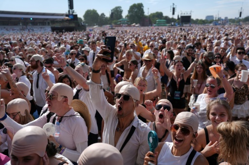 Des fans du rappeur américain Pitbull portent de faux crânes chauves avant un concert de l'artiste, le 10 juillet 2026 à Londres