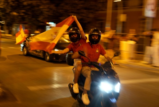 Spanish football fans are just warming up as celebrations will carry on into Monday when the team returns for a victory parade — Paul Hanna / AFP