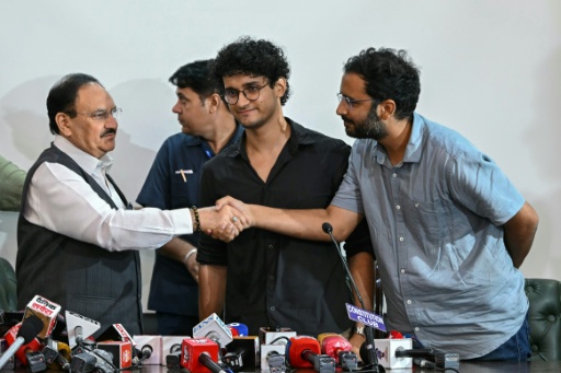 Cockroach Janta Party spokespersons Ashutosh Ranka (R) and Saurav Das (C) greet India's Health Minister JP Nadda — Arun SANKAR / AFP