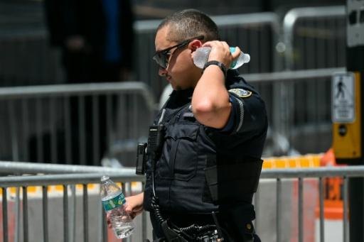 Un policier se rafraichit avec une bouteille d'eau lors d'une vague de chaleur le 3 juillet 2026 à New York — ANGELA WEISS / AFP
