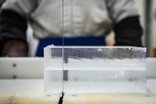 Un travailleur découpe de la glace au sein de l'usine Kuramoto Ice à Kanazawa, au Japon, le 15 juin 2026 — Yuichi YAMAZAKI / AFP
