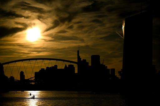 People row on the river in front of the European Central Bank's headquarters and banking district in Frankfurt — Kirill KUDRYAVTSEV / AFP