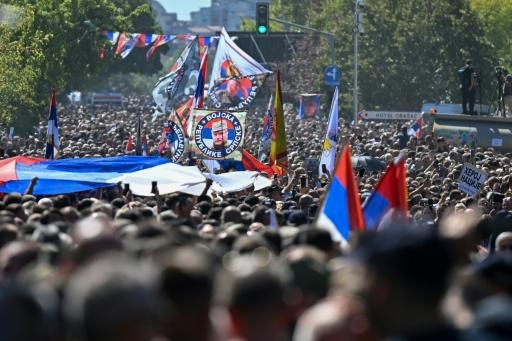 Crowds lined the street in Belgrade, waving flags bearing the former general's face — OLIVER BUNIC / AFP