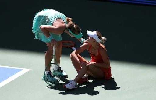 Russia's Mirra Andreeva checks on Anastasia Potapova after the Austrian fell during the final game in Andreeva's fourth-round US Open win — TIMOTHY A. CLARY / AFP