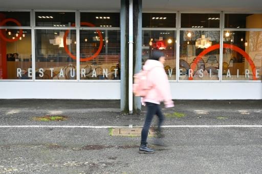 A student walks by Rennes II university restaurant Le Metronome, before an action called by various students unions to protest against students poverty in Rennes, western France, on November 26, 2016. — Damien MEYER / AFP