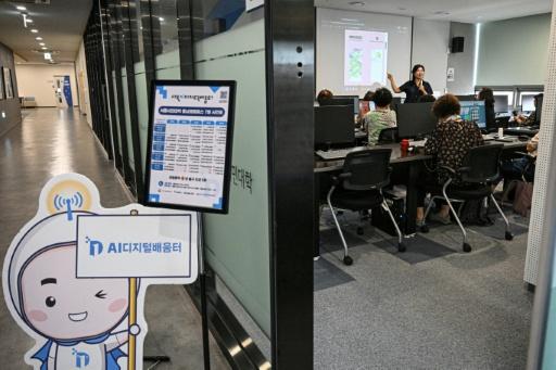 Older people attending a class on how to navigate AI-powered applications at Seoul Open City University — Jade GAO / AFP