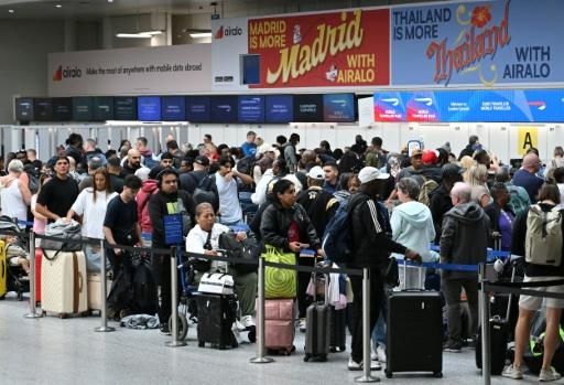 More than 330,000 passengers were affected by the glitch over two days — JUSTIN TALLIS / AFP