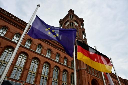 The flags of European Union, Germany and Berlin fly at half-mast in front of Berlin's city hall (Rotes Rathaus) — John MACDOUGALL / AFP