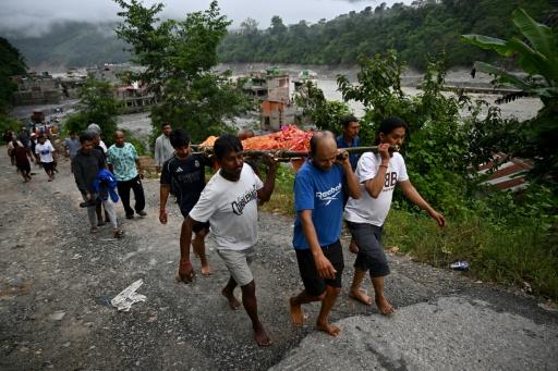 Mourners carry a body during a funeral ceremony in Nepal's Nuwakot district on Monday — Pedro PARDO / AFP