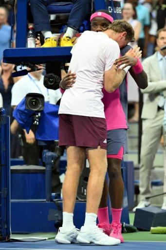 Alex Michelsen is consoled by Frances Tiafoe after falling to the 11th seed in five sets  in the US Open quarter-finals — ANGELA WEISS / AFP